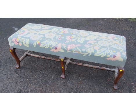 An upholstered stool bench/stool, the tapestry covered top with floral decoration, raised on oak scroll legs united by turned