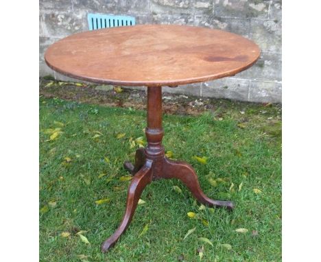 An Antique mahogany tripod table, with tilt top, raised on a turned column and three outswept supports, diameter 30ins, heigh