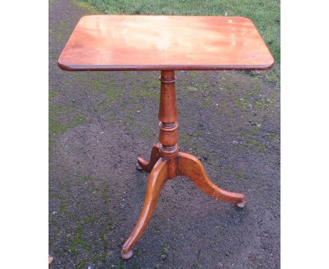 A 19th century mahogany rectangular topped tripod table, with tilt top raised on a turned column to three supports, 22.5ins x