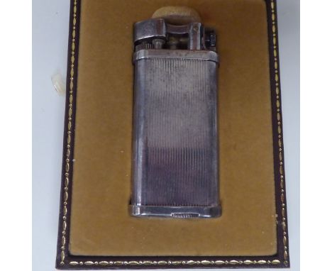 A vintage Dunhill silver plated cased, petrol filled cigarette lighter&nbsp; boxed 