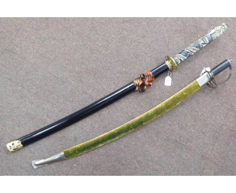 A modern Japanese sword, the curved blade 28"L in a scabbard; and a contemporary sabre, the curved blade 29"L in a fabric cov
