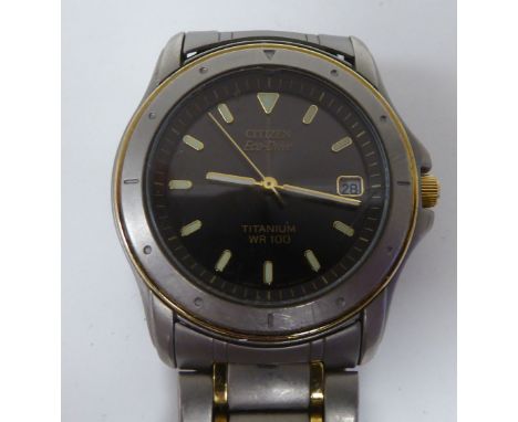 A Citizen Eco-Drive titanium and yellow metal cased bracelet wristwatch, faced by a baton dial, incorporating a date aperture