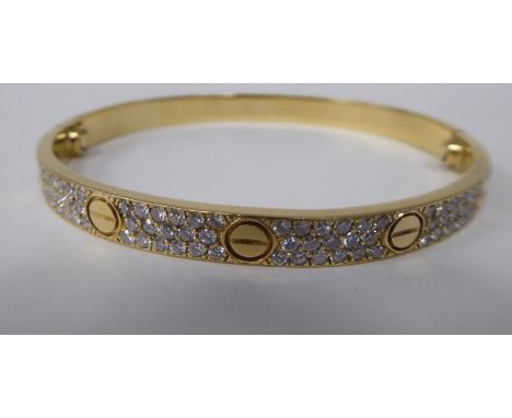 A Cartier style 18ct gold diamond set 'Love' style bangle&nbsp; stamped 750&nbsp;