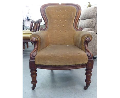 A mid Victorian mahogany showwood framed spoonback chair, part button upholstered in stone coloured fabric, raised on cabriol