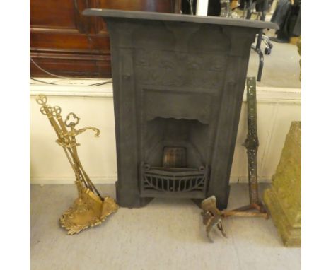 An early 20thC cast iron fire surround and back, decorated in relief with flora&nbsp; 41"h&nbsp; 30"w; and a set of brass fir