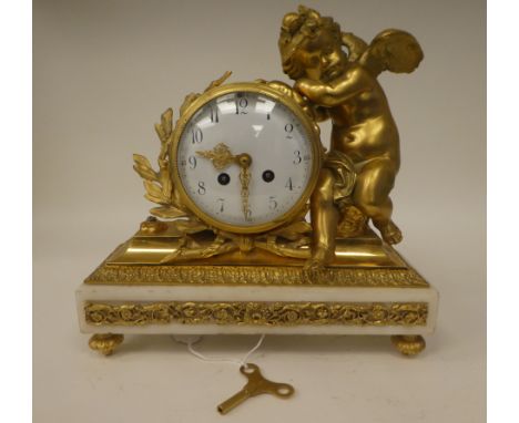 A late 19thC white marble and gilt metal mounted mantel clock, the barrel case surmounted by a resting cherubic figure; the b