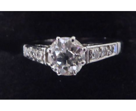 A white coloured metal, single stone, claw set diamond ring with diamond shoulders&nbsp; stamped Plat&nbsp; with a certificat