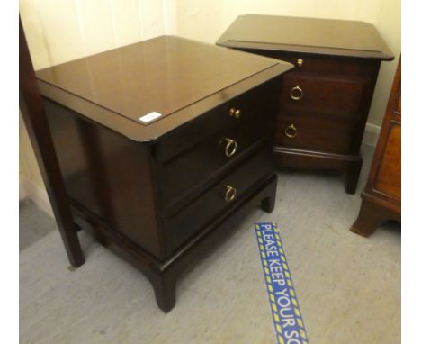 A pair of Stag mahogany finished dressing chests, each with a slide, over two drawers, raised on bracket feet&nbsp; 21"h&nbsp
