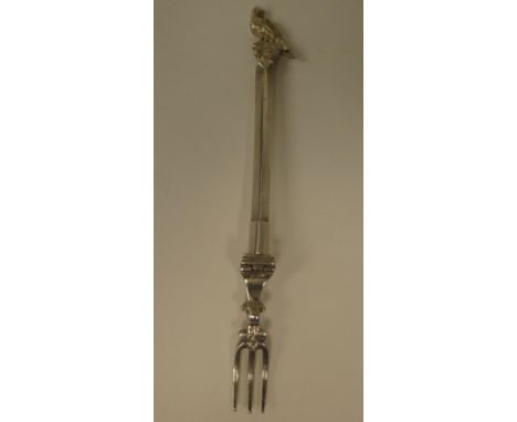 A vintage white metal campaign fork, the tines folding on a square stem with a sleeve fitting and bird finial 