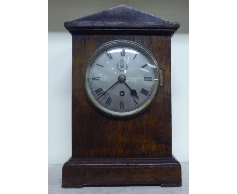 A 1920s oak cased mantel clock; the movement faced by a Roman dial with an RAF emblem&nbsp; 14"h&nbsp; 9"w&nbsp; 