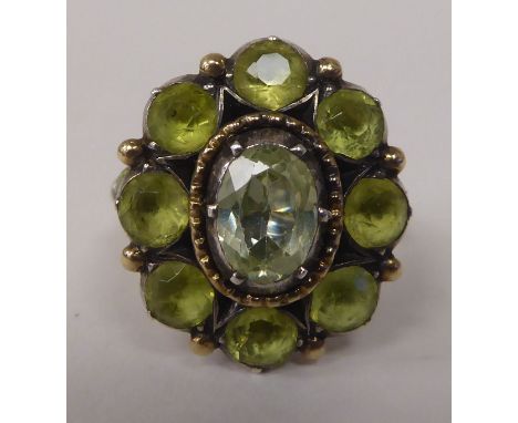 A gold coloured metal peridot set cluster ring&nbsp; 