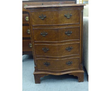 A modern walnut veneered serpentine front dressing chest with four drawers, raised on bracket feet&nbsp; 30"h&nbsp; 20"w&nbsp