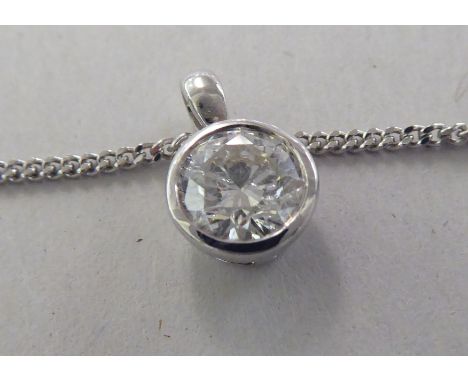 A white gold pendant, set with a single diamond, on a fine neckchain and ring bolt clasp&nbsp; stamped 750&nbsp; 