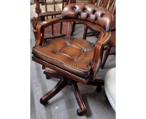 Reproduction leather button back and mahogany finish office swivel armchair. (B.P. 21% + VAT)