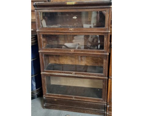 Early 20th century oak Globe Wernicke four sectional bookcase with presentation plaque dated 1927. Plaque to the back panel '