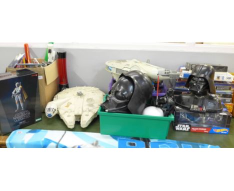 A large collection of Star Wars items including toys, Millennium Falcon x2, jigsaws, figures, DVD Trivial Pursuit, a lamp, et