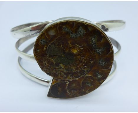 A silver bangle set with an ammonite fossil, fossil 44mm x 37mm