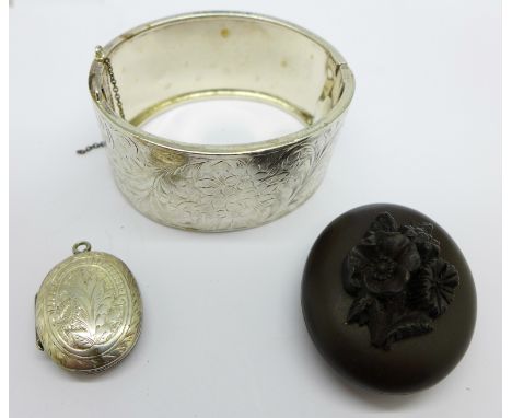 A silver bangle, fastener a/f, and two lockets, bog oak a/f