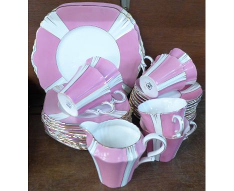 Royal Albert Art Deco teaware in pink and white, (six cups, ten saucers, twelve side plates, two cake plates and one milk jug