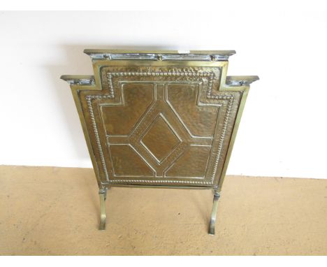 A 1930s planished brass firescreen