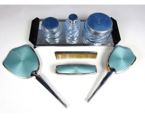 Vintage dressing table items, including three cosmetic bottles with guilloche engraved and cornflower blue enamelled lids, an