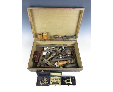 A wooden box containing vintage watchmakers' tools etc.