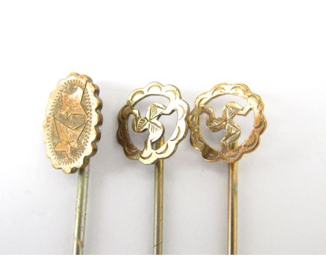 A late 19th Century rolled gold stick pin, together with two further similar 