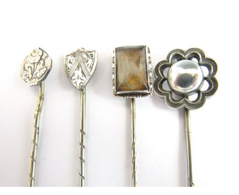 A vintage white metal and butterfly wing stick pin, stamped sterling silver, together with three further white metal stick pi