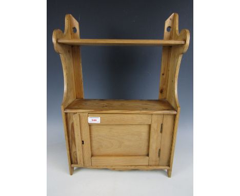 A small pine wall hanging cupboard with shelf