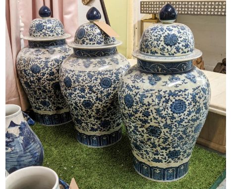 TEMPLE JARS, a set of three, 73cm H, Chinese Export style, blue and white ceramic, chrysanthemum decoration. (3) 