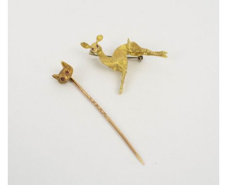 AN 18ct GOLD FAWN BROOCH, Italian, set with ruby eyes, rusticated finish, 3.5cm long, 8.7 grams; together with a 15ct fox hat