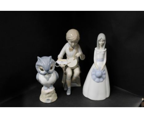 Three Nao style figurines, drummer boy, lady and owl