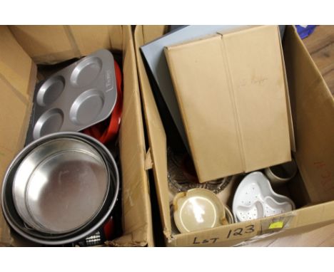 Two boxes of baking equipment, ceramic items and old newspapers 