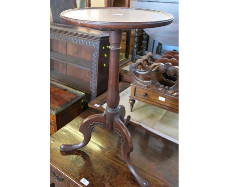 A 19th century mahogany tripod table, with turned column terminating in three outswept feet, diameter 16ins 