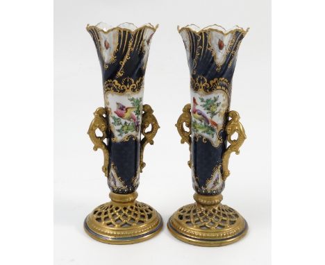 A pair of Graingers Worcester spill vases, decorated with reserved panels of fabulous birds and insects to a scale blue groun