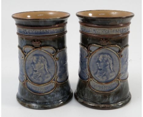 A pair of Royal Doulton stoneware vases, commemorating Lord Nelson, with ships, portrait and motto, impressed X6423, height 5