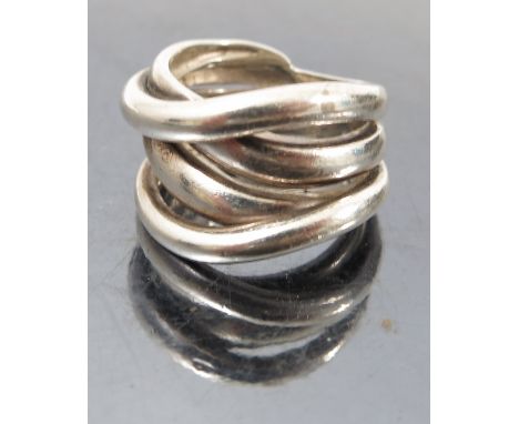 A silver ring, formed as four various bands, marked '925'
