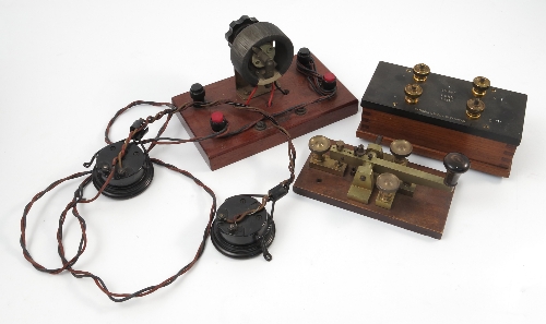 A brass morse code machine, on mahogany base, together with a Gambrell ...