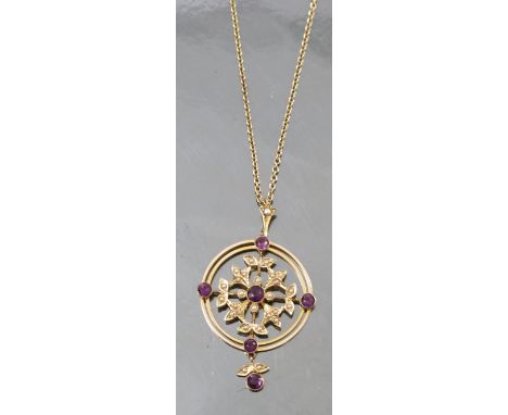 An Edwardian amethyst and seed pearl pendant, on a chain, the pendant tagged '15ct', of circular outline with amethysts to th