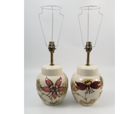 A pair of Moorcroft pottery lamp bases, decorated in the Columbine pattern to a white ground, height excluding fitting 8.25in