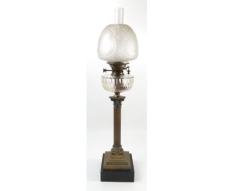 A Hinks Benetfink London Duplex glass and brass column oil lamp, having a Corinthian capital, faceted glass reserve, with fro