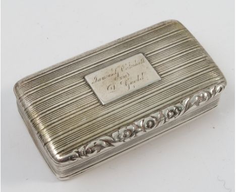 A Georgian silver snuff box, with ribbed decoration, embossed flowers to lip and presentation inscription, Birmingham 1827, m