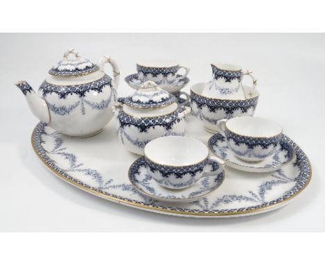 A Royal Worcester cabaret set, decorated with floral swags and border in blue, with gilt highlights, comprising four teacups 