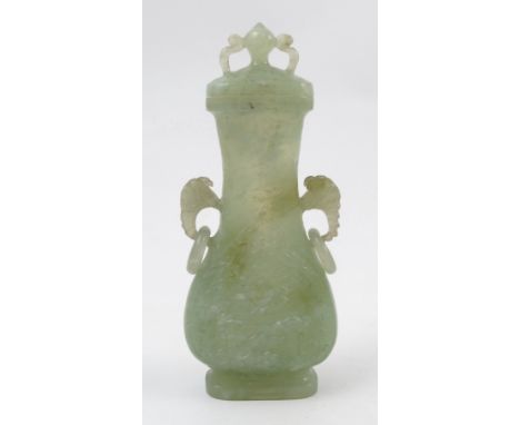 A Chinese carved jade STYLE covered vase, of oval baluster form, with ring handles, height 6ins P;EASE NOTE NOT GUARANTEED AS