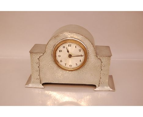 An Arts &amp; Crafts pewter mantle clock, 29cm wide, lacks rear cover