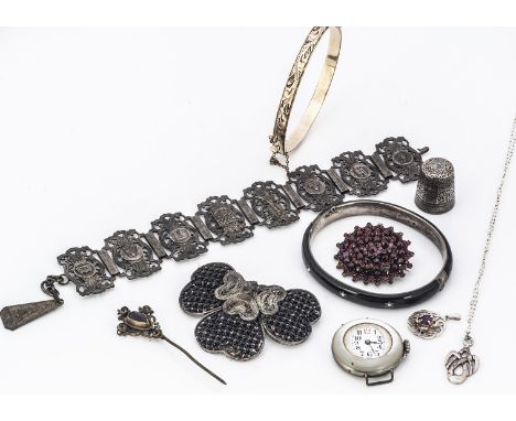 A continental white metal and black enamel hinged bangle bearing French strike marks, with seed pearls in gypsy settings, mar