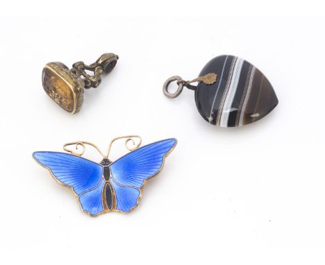 A David Andersen Norwegian silver and enamel butterfly brooch, together with an agate heart shaped charm and a pinchbeck and 