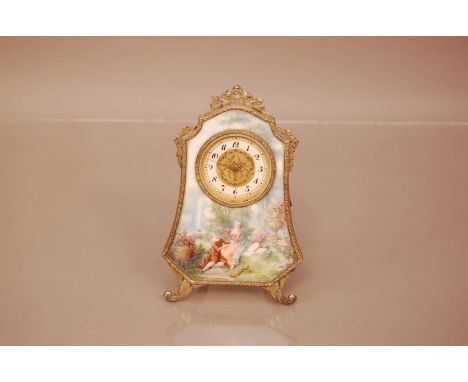 A late 19th or early 20th century French enamelled dressing table clock, 13.5cm, with scene of courting couple in garden, the