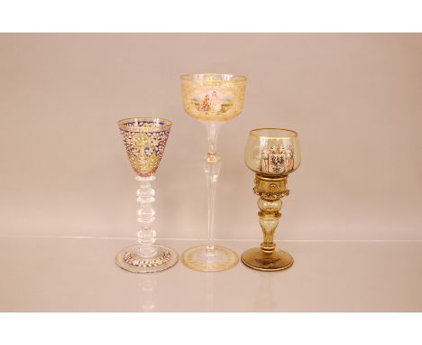 Three late 19th and early 20th century German enamelled glasses, the tallest, 27cm, with cut and gilt decoration and painted 