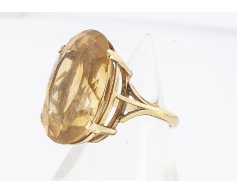 A citrine oval mixed cut yellow metal set dress ring, in four claw setting, on a yellow metal shank marked 18ct, ring size K,